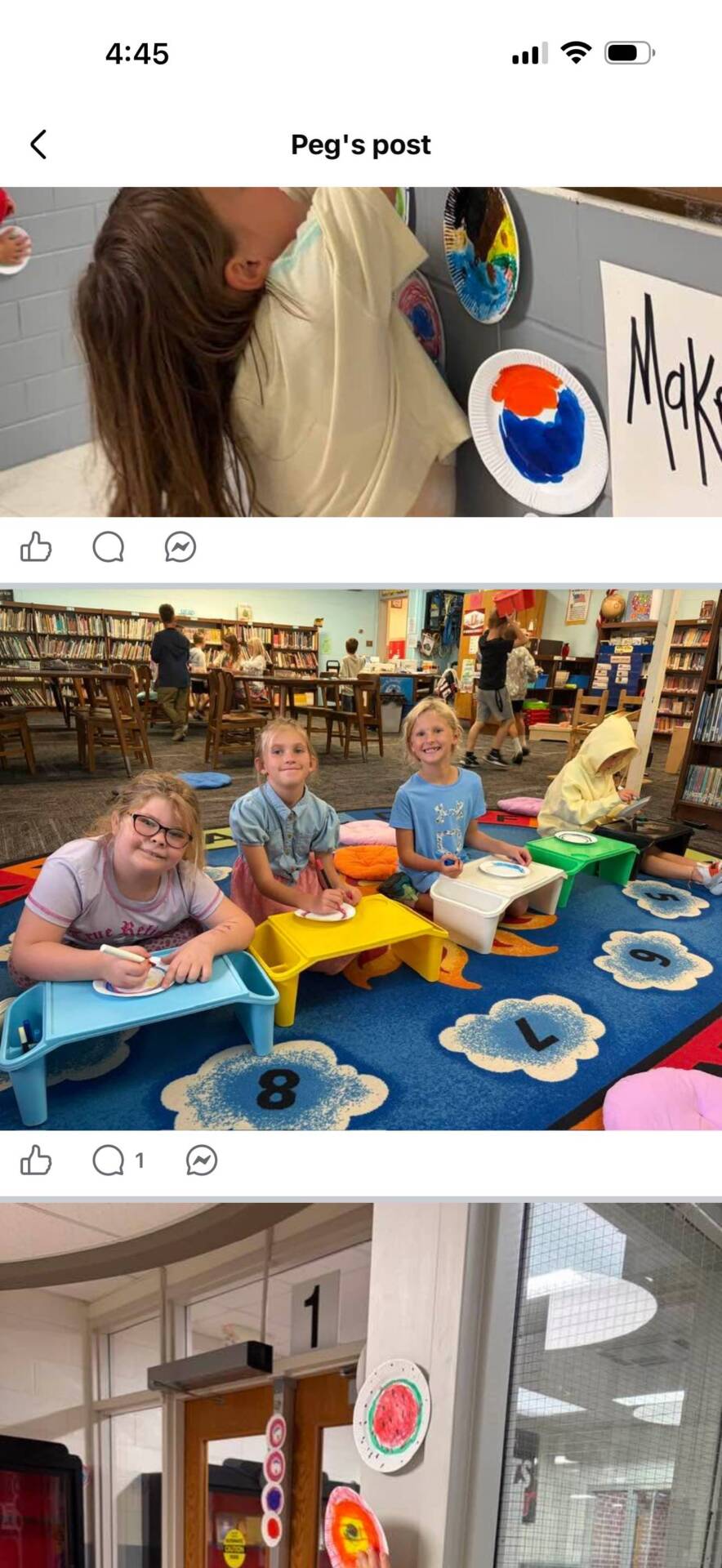 elementary students seated at colorful lap desks in a school library while working on an art activity.