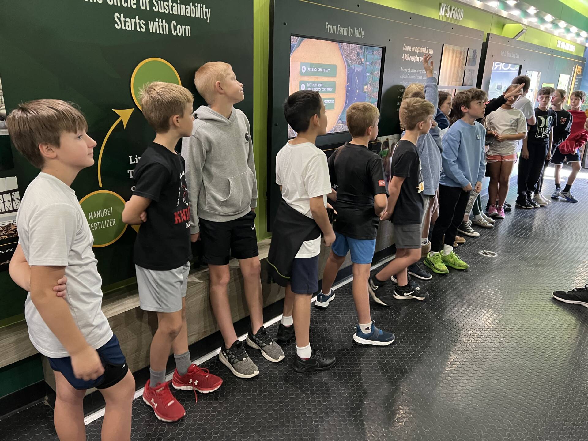 Students explore interactive displays about corn production, farming, and sustainability inside the Iowa Corn educational trailer.