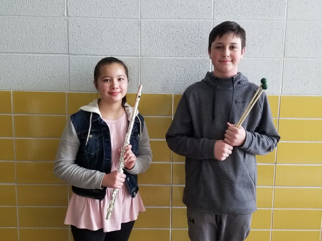Boy and Girl holding instruments