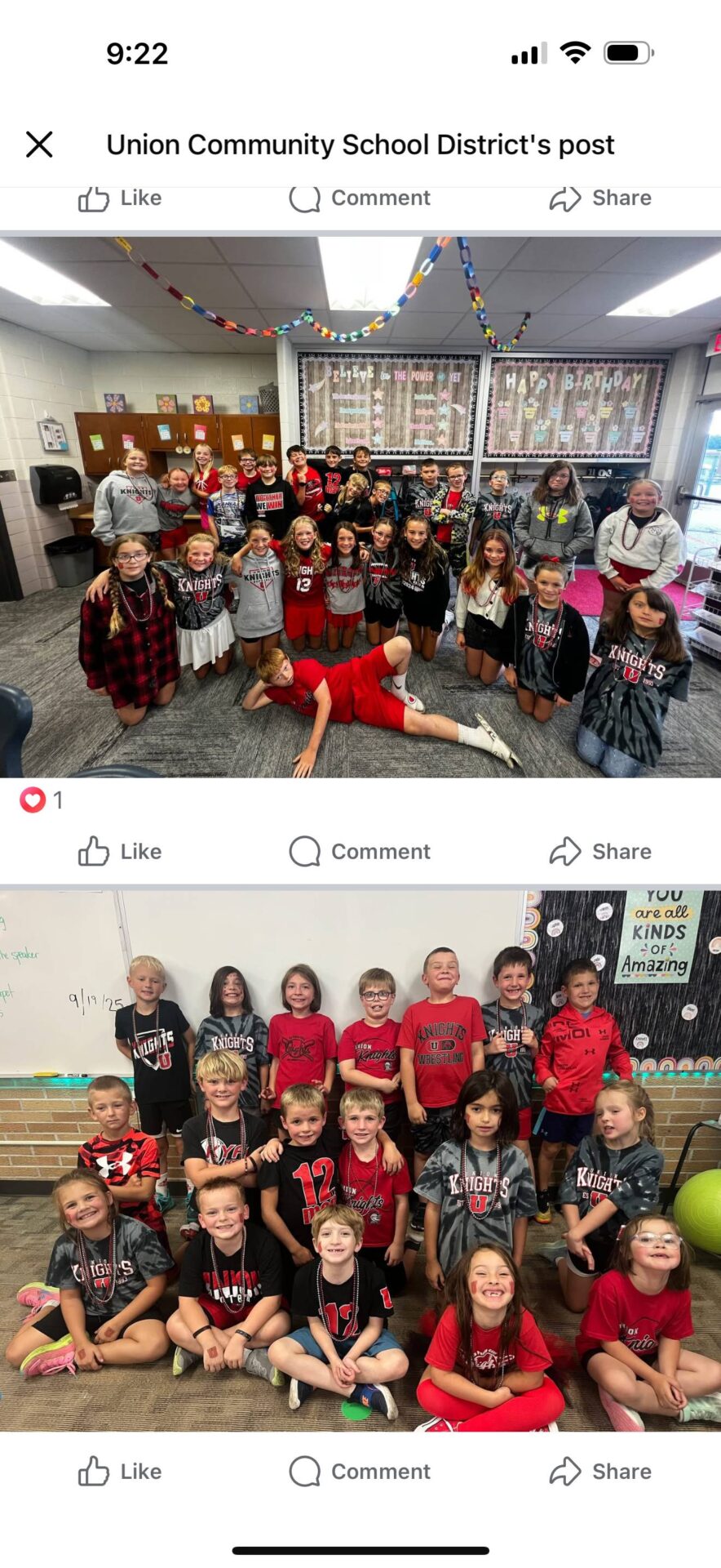 Older elementary students in red and black spirit wear posing together.