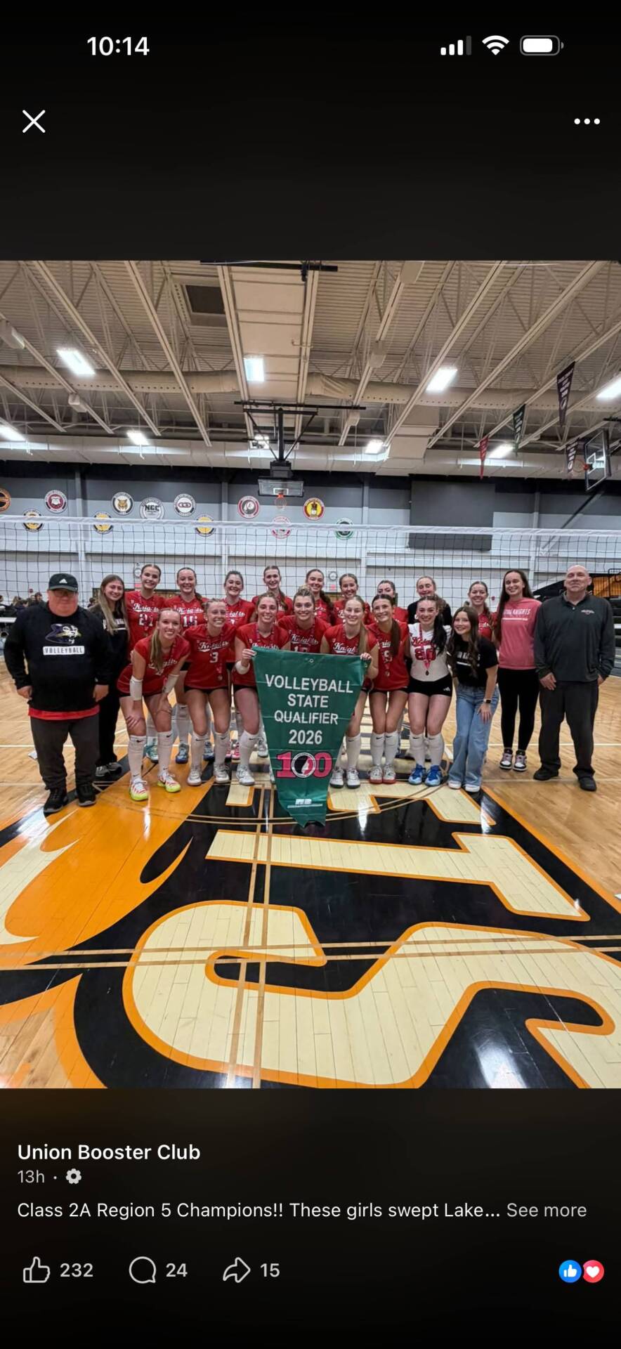 Union volleyball players and coaches pose with a 2026 Volleyball State Qualifier banner after winning the regional championship.